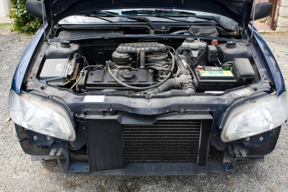 Engine cooling radiator exposed at the front of a vehicle with its bumper removed